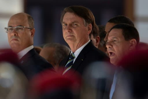 Brazilian President Jair Bolsonaro (C), seen here at a ceremony marking the 130th anniversary of the Rio de Janeiro Military School (CMRJ), was the target of protests over deep budget cuts in public education