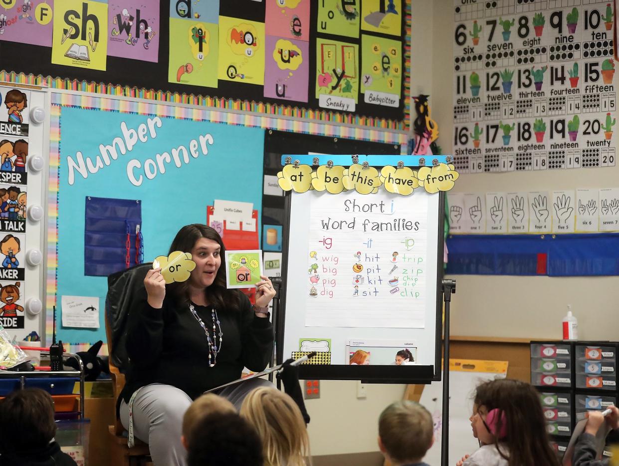 Teacher Ashleigh Schiano-Oliver works with her kindergarten students on reading, writing and pronunciation at Bremerton's Armin Jahr Elementary on Nov. 16. Schiano-Oliver was recently chosen as a winner of $5,000 award from an organization called "Honored," which is dedicated to keeping great teachers in the classroom.