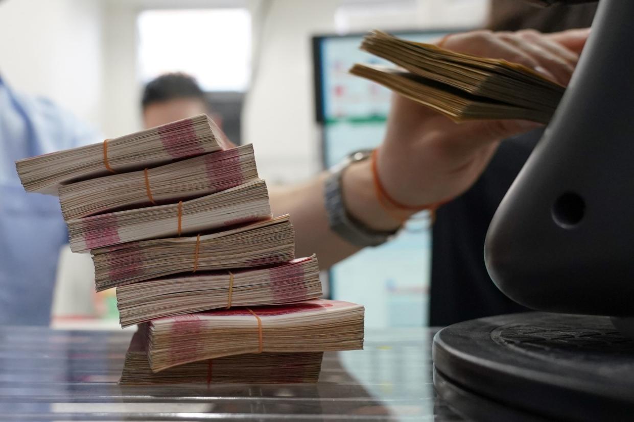 Bundles of Chinese yuan banknotes at the Ninja Money Exchange, operated by Interbank HD, in the Shinjuku district of Tokyo, Japan, on Thursday, June 9, 2022. Caught in the crossfire between the two wildly different monetary policy regimes in Tokyo and Washington, at one point Tuesday, the Japanese currency was less than one yen away from its 2002 high of 135.15 per dollar. Photographer: Toru Hanai/Bloomberg