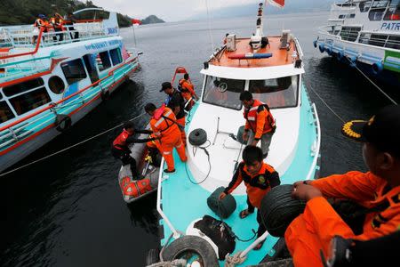 Rescuers prepare tools for a search and rescue operation for missing passengers from Monday's ferry accident at Lake Toba at Tigaras port in Simalungun, North Sumatra, Indonesia, June 21, 2018. REUTERS/Beawiharta