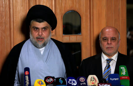Iraqi Shi'ite cleric Moqtada al-Sadr, who's bloc came first, speaks during a news conference with Iraqi Prime Minister Haider al-Abadi, who's political bloc came third in a May parliamentary election, in Najaf, Iraq June 23, 2018. REUTERS/Alaa al-Marjani