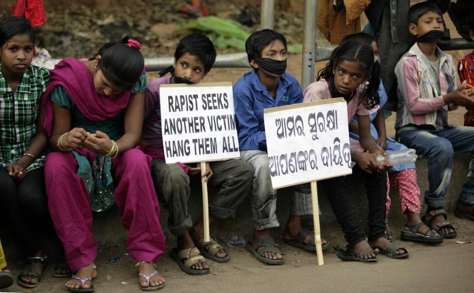 Indian children participate in a protest against child abuse and rising crimes against women, in Bhubaneswar, India, Saturday, March 16, 2013. India has seen outrage and widespread protests against rape and attacks on women and minors since a fatal gang-rape of a young woman in December on a moving bus in New Delhi, the capital. In the most recent case, a Swiss woman who was on a cycling trip in central India with her husband has been gang-raped by eight men, police said. Placard reads "our safety is your responsibility." (AP Photo/Biswaranjan Rout)