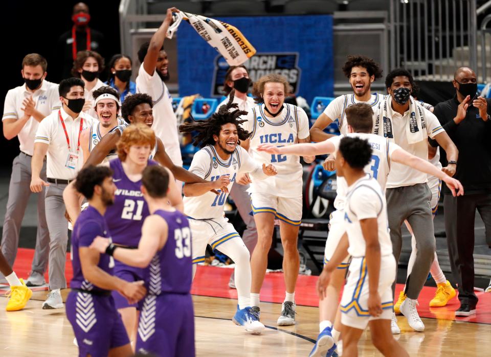 UCLA players celebrate after defeating Abilene Christian during the second round of the 2021 NCAA Tournament on Monday, March 22, 2021, at Bankers Life Fieldhouse.