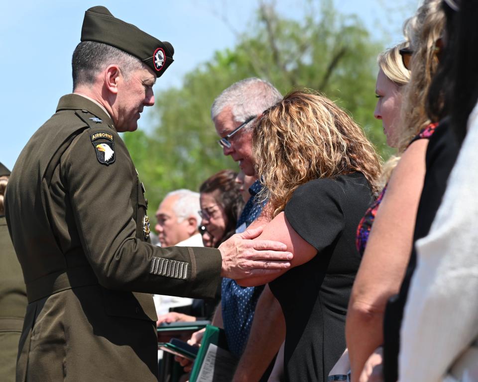 Maj. Gen. JP McGee, commander of the 101st Airborne Division (Air Assault), presents a Meritorious Service Medal to the family of a fallen Soldier during a posthumous award ceremony, at Clarksville, Tenn., April 13, 2023.