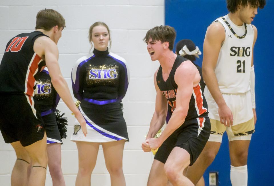 Metamora's Tyler Mason, left, and Drew Tucker, middle, celebrate after Tucker took a foul from SH-G's Zack Hawkinson, right, on a successful layup in the first half Monday, Jan. 16, 2023 at UI-Springfield. The Redbirds defeated the defending 3A state champion Cyclones 60-50.