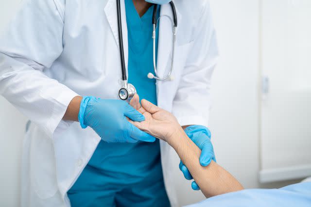 <p>Getty</p> Stock image of a doctor holding a patient's arm