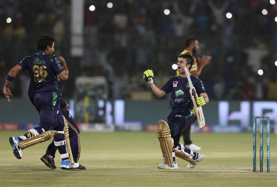 Quetta Gladiator batsman Ahmed Shahzad, right, celebrate with teammates after won the final cricket match of Pakistan Super League against Peshawar Zalmi at National stadium in Karachi, Pakistan, Sunday, March 17, 2019. (AP Photo/Fareed Khan)