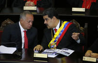 Venezuelan President Nicolas Maduro, right, speaks with Constitutional Assembly President Diosdado Cabello at the Supreme Court during an annual ceremony that marks the start of the judicial year in Caracas, Venezuela, Thursday, Jan. 24, 2019. Cabello and other high-ranking allies pledged to stand behind Maduro and denounced Juan Guaido who declared himself interim president on Wednesday. (AP Photo/Ariana Cubillos)