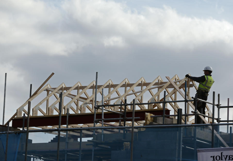 Construction workers building the roof of a new house under construction at Taylor Wimpey�s Churchill Place development in Mill Hill, London. PRESS ASSOCIATION Photo. Picture date: Friday March 27, 2015. Photo credit should read: Yui Mok/PA Wire 