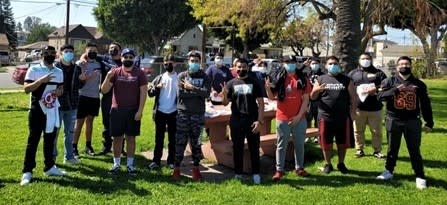 Roosevelt football players gather at a local park to pick up memorabilia of "Coach Dicky" from Guillen's family.