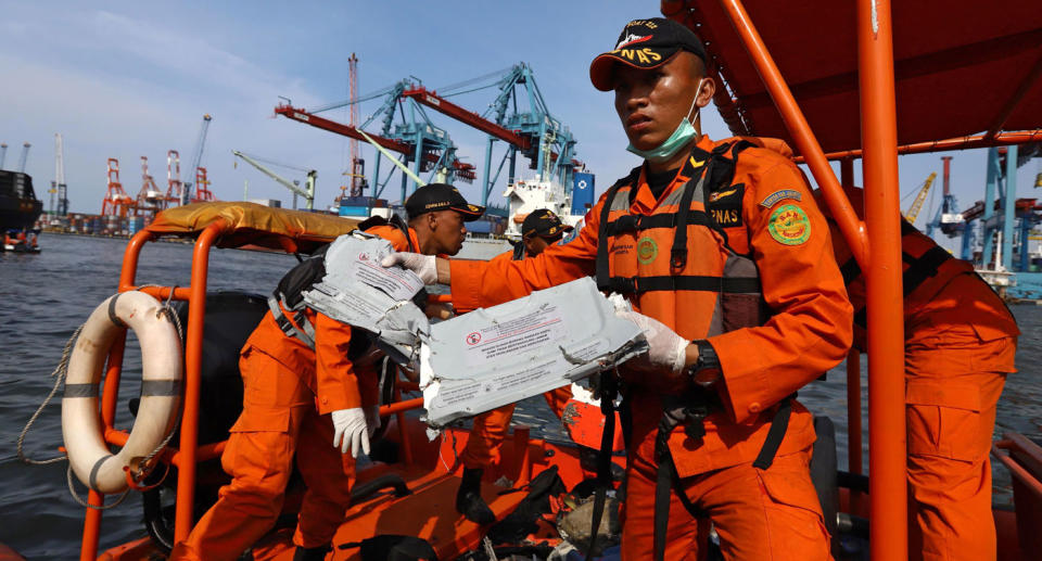 Members of a rescue team bring ashore personal items and wreckage from Lion Air flight JT 610 at the port in Tanjung Priok, North Jakarta. Source: Getty Images