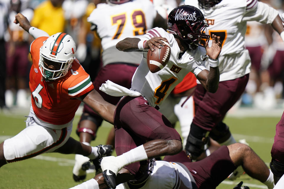 Bethune Cookman quarterback Jalon Jones (4) runs past Miami defensive lineman Darrell Jackson Jr. (6) during the first half of an NCAA college football game, Saturday, Sept. 3, 2022, in Miami Gardens, Fla. (AP Photo/Lynne Sladky)