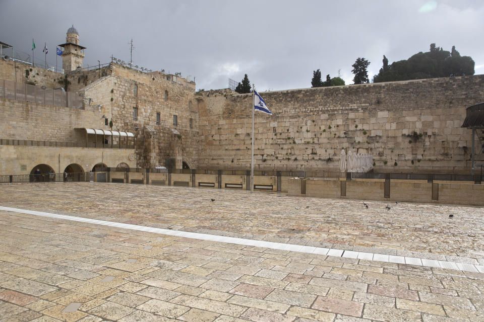 The Western Wall, the holiest site where Jews can pray, in Jerusalem's Old City, is empty Friday, April 10, 2020. Christians are commemorating Jesus' crucifixion without the solemn church services or emotional processions of past years, marking Good Friday in a world locked down by the coronavirus pandemic. (AP Photo/Sebastian Scheiner)