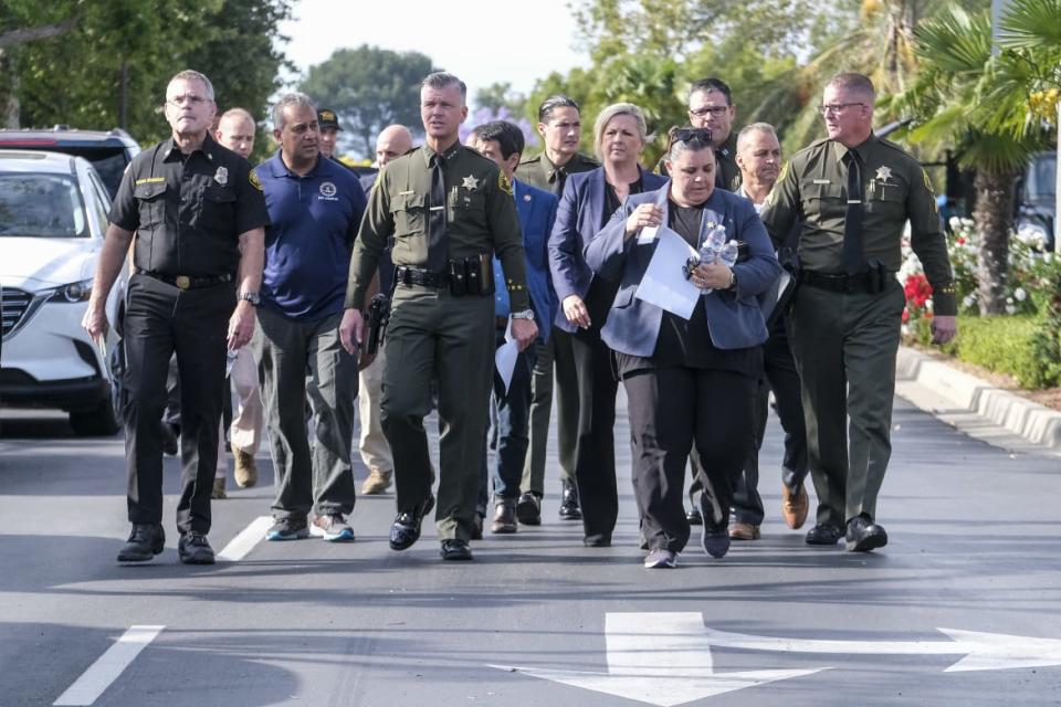 <div class="inline-image__caption"><p>Officials gather at the Geneva Presbyterian Church in Laguna Woods, California, after the shooting.</p></div> <div class="inline-image__credit">Ringo Chiu/Getty</div>