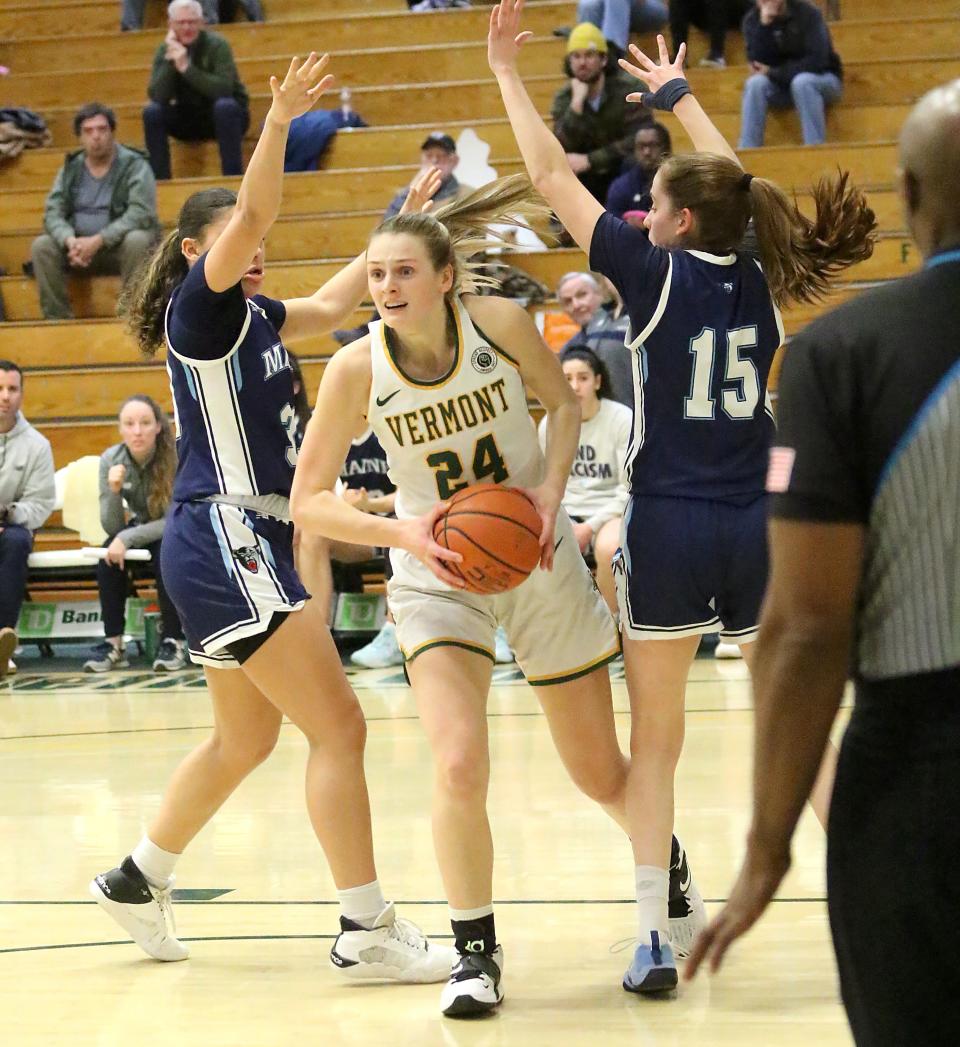 Vermont's Anna Olson splits two Maine defenders during the Catamounts 68-60 win over the Black Bears on Wednesday night at UVM's Patrick Gym.