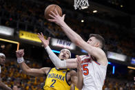 New York Knicks center Isaiah Hartenstein (55) fights for a rebound with Indiana Pacers guard Andrew Nembhard (2) during the first half of Game 3 in an NBA basketball second-round playoff series, Friday, May 10, 2024, in Indianapolis. (AP Photo/Michael Conroy)