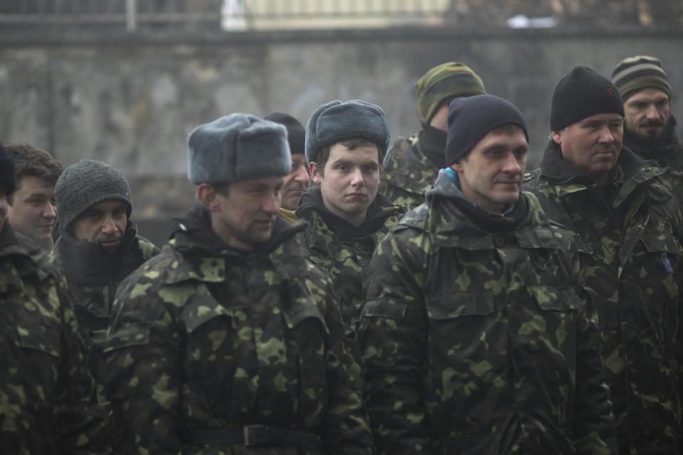 Ukrainian recruits receive military instructions from a commander at a recruitment center at Kiev's Independence Square, Ukraine, Tuesday, March 4, 2014. Vladimir Putin ordered tens of thousands of Russian troops participating in military exercises near Ukraine's border to return to their bases as U.S. Secretary of State John Kerry was on his way to Kiev. Tensions remained high in the strategic Ukrainian peninsula of Crimea with troops loyal to Moscow fired warning shots to ward off protesting Ukrainian soldiers. (AP Photo/Emilio Morenatti)