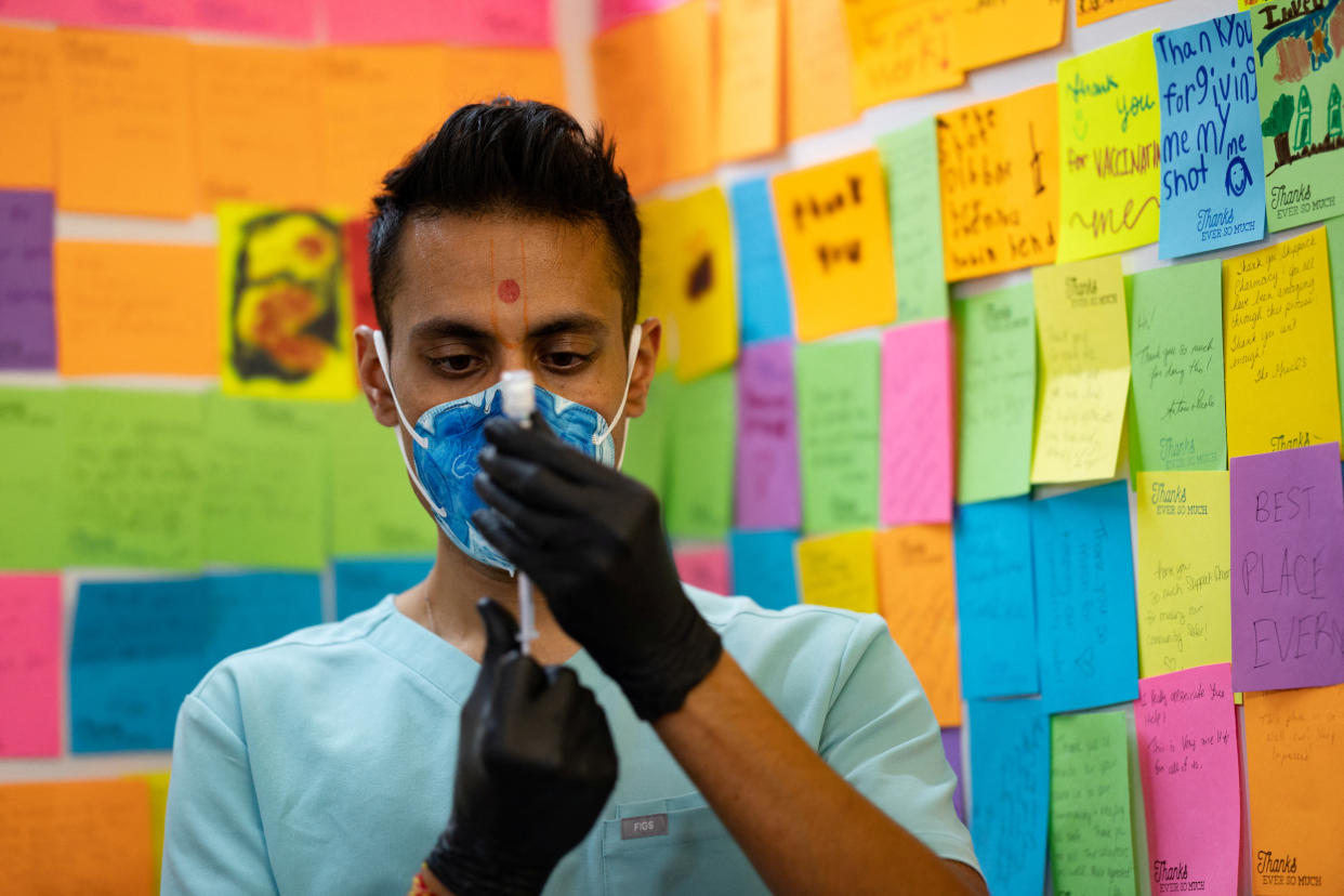 Dr. Mayank Amin draws a COVID booster vaccine targeting Omicron subvariants at Skippack Pharmacy in Schwenksville, Pennsylvania, September 8, 2022. REUTERS/Hannah Beier