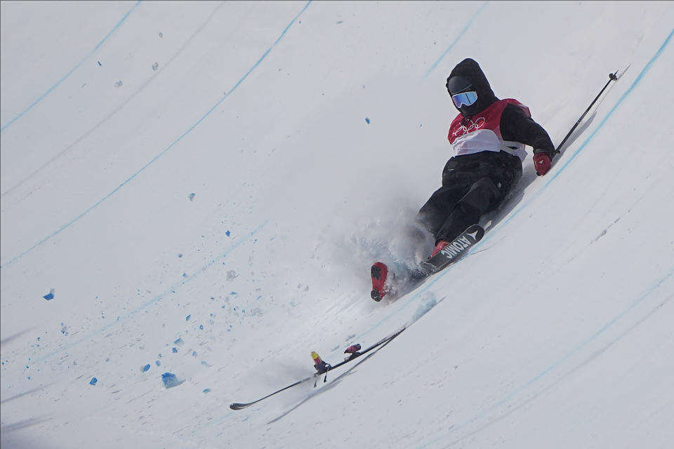 Britain's Gus Kenworthy crashes during the men's halfpipe finals at the 2022 Winter Olympics, Saturday, Feb. 19, 2022, in Zhangjiakou, China. (AP Photo/Gregory Bull)