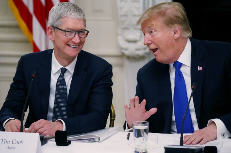 FILE PHOTO: Apple CEO Cook and U.S. President Trump participate in American Workforce Policy Advisory Board meeting at the White House in Washington