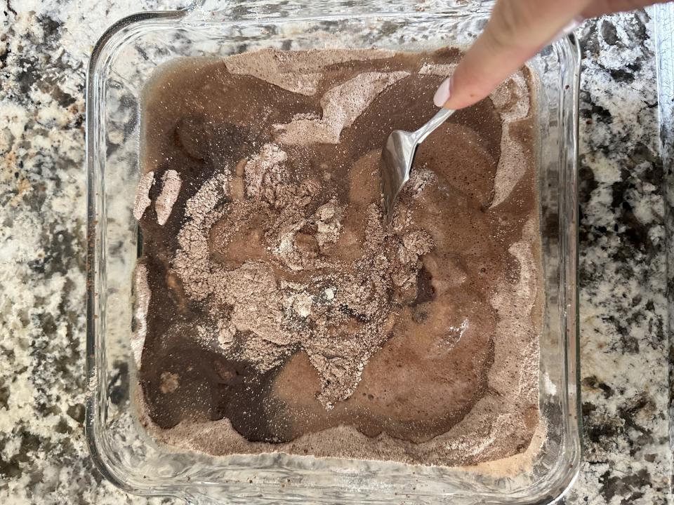 the author using a fork to stir the cake mixture together