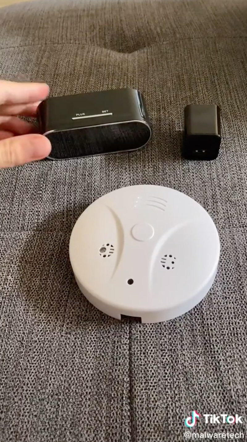 The smoke alarm, alarm clock, and charger box that the video used in the demonstration