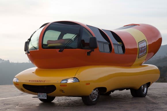 The Oscar Mayer Wienermobile parked on a highway.