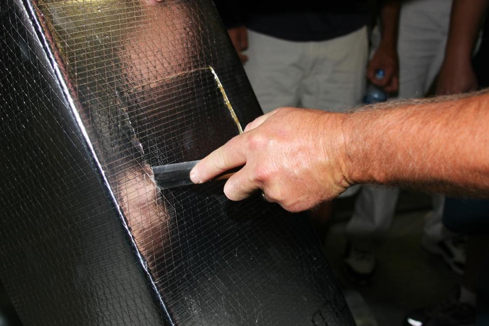 This undated publicity photo provided by NADCA shows a technician cutting an access hole in ductwork. If you want to freshen up the air in your home and make your heating and cooling systems work more efficiently, you might consider having the ductwork cleaned. (AP Photo/NADCA)