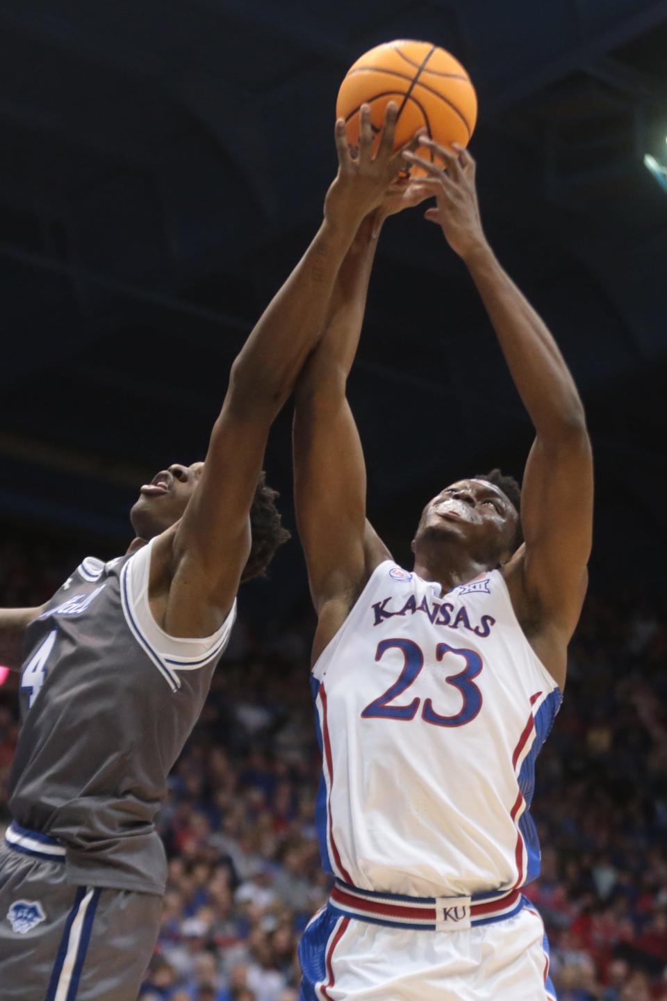 Kansas freshman center Ernest Udeh Jr. (23) fights for a rebound against Seton Hall forward Tyrese Samuel (4) during the second half of Thursday's game inside Allen Fieldhouse.