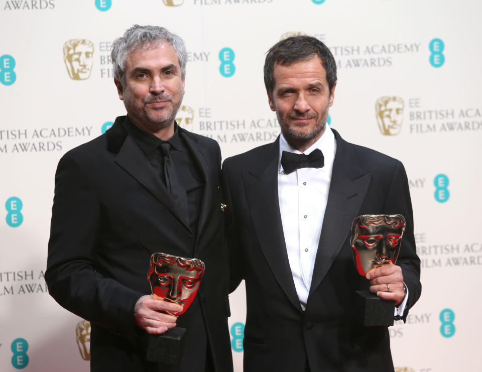 Alfonso Cuaron and David Heyman, winners of outstanding British film for Gravity, pose for photographers in the winners room at the EE British Academy Film Awards held at the Royal Opera House on Sunday Feb. 16, 2014, in London. (Photo by Joel Ryan/Invision/AP)