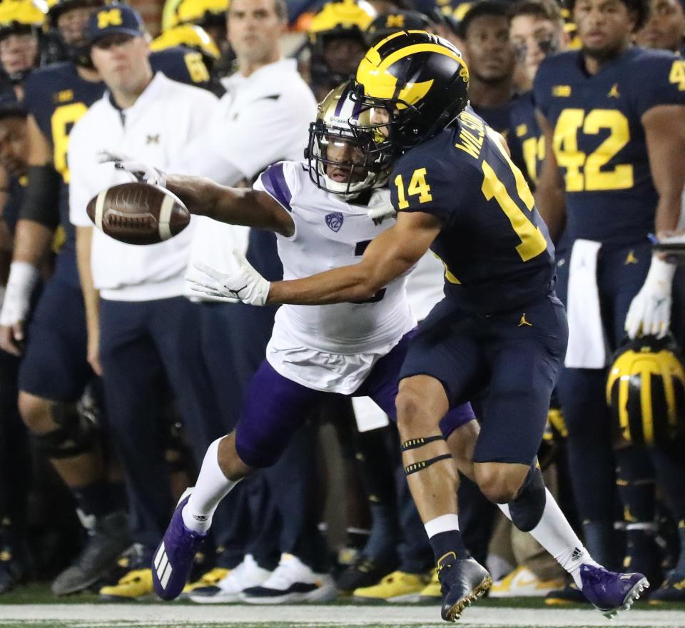 Michigan Wolverines wide receiver Roman Wilson (14) is defended by Washington Huskies defensive back Kyler Gordon (2) Saturday, Sept. 11, 2021 at Michigan Stadium.