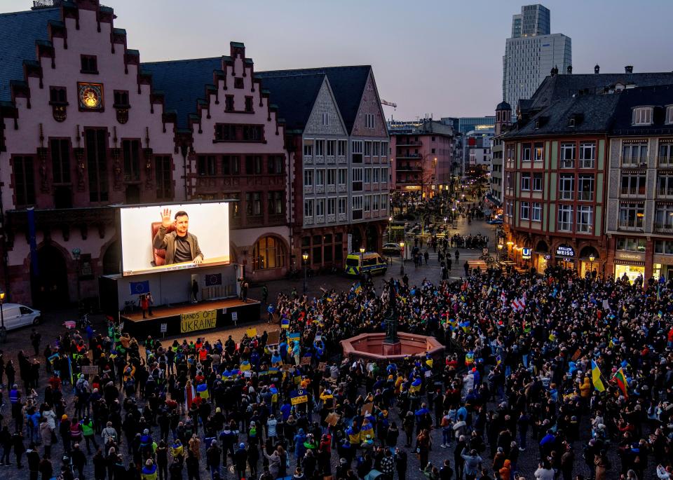 Ukrainian President Volodymyr Zelenskyy delivers a video message to the people joining a rally on the Remember square in Frankfurt, Germany.