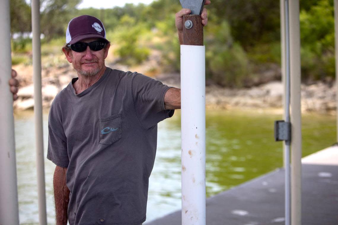 Duaine Cook checks on Wednesday, July 20, 2022, on a house he built on the shore of Possum Kingdom Lake after a wildfire began Monday in Graford, Texas.