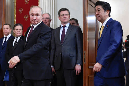 Russian President Vladimir Putin (L, front) and Japanese Prime Minister Shinzo Abe (R) walk before making a joint statement following their meeting at the Kremlin in Moscow, Russia January 22, 2019. Alexander Nemenov/Pool via REUTERS