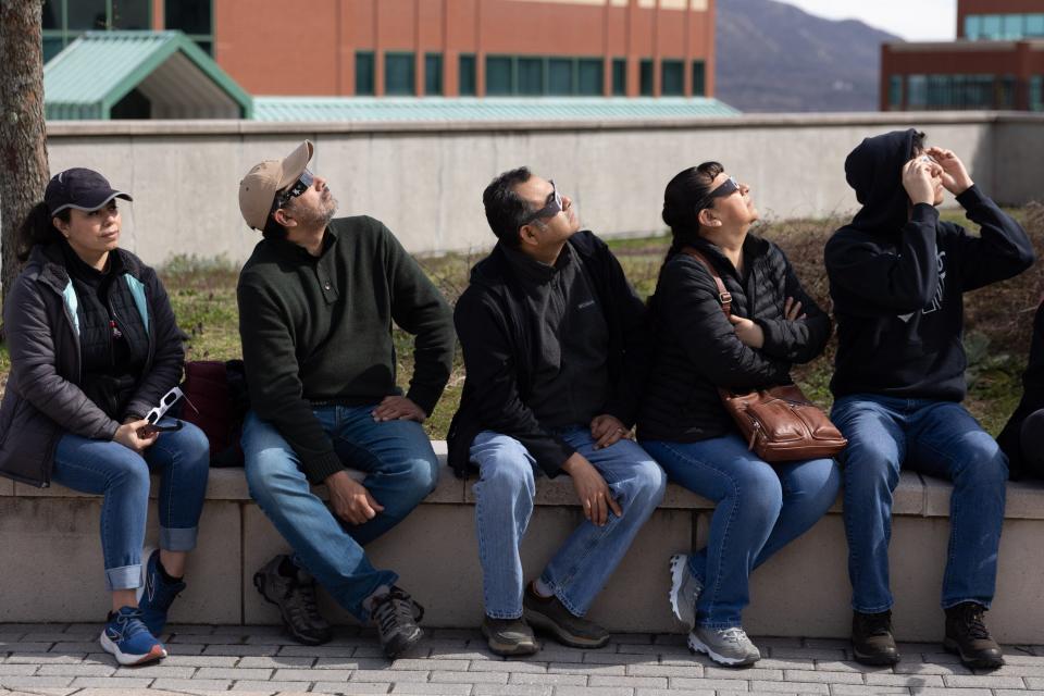 Claudia Ayaquica, Jose Rodriguez, Benjamin Morales, Mireyra Dorantes and Ben Morales joins over 100 solar eclipse spectators at SUNY Orange during a partial solar eclipse in Newburgh, NY on April 8, 2024.