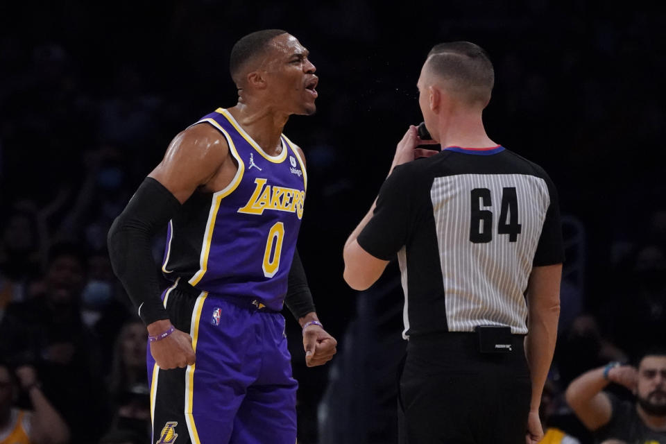 Los Angeles Lakers guard Russell Westbrook, left, reacts after scoring during the first half of an NBA basketball game against the Phoenix Suns, Friday, Oct. 22, 2021, in Los Angeles. (AP Photo/Marcio Jose Sanchez)