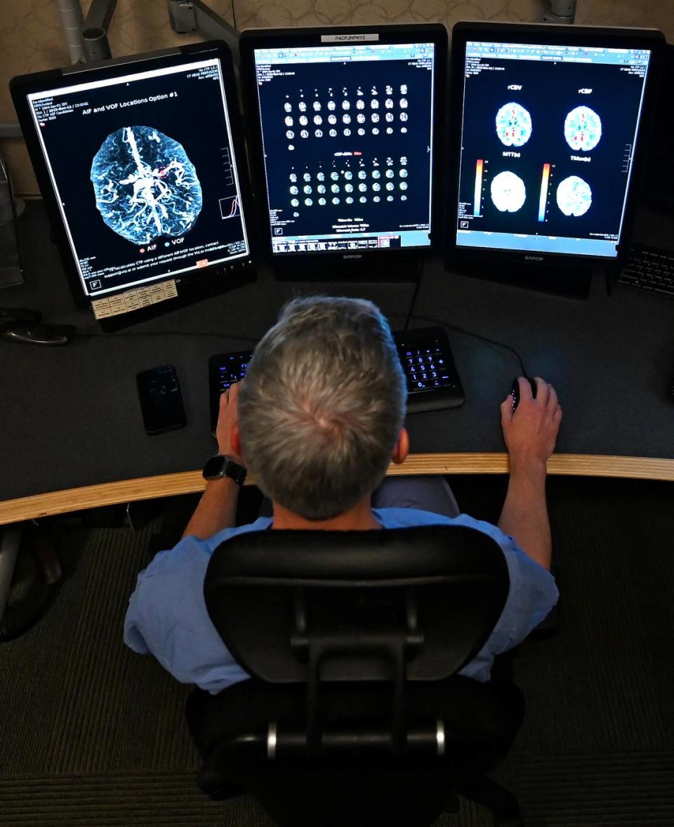 Dr. Andrew Griffin II, MD, a neuro-interventional radiologist at Novant Health Presbyterian Medical Center in Charlotte analyzes a patient's brain scans, using an AI technology to detect possible stroke.