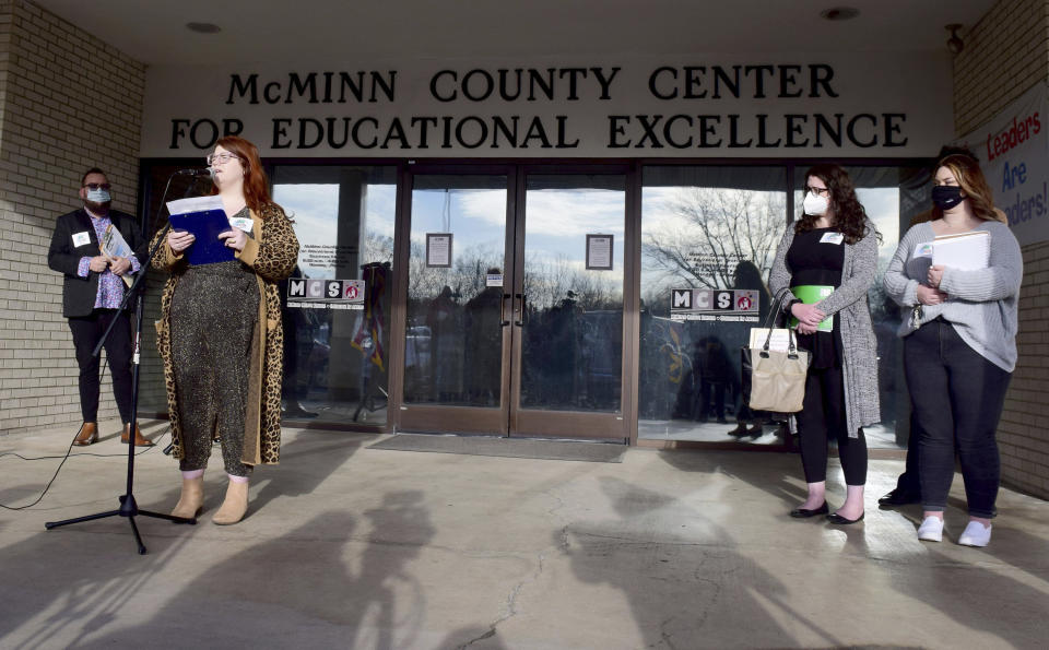 Tennessee Wesleyan University Media Specialist Alex Sharp, second left, speaks during the McMinn County Neighbors press conference, Thursday, Feb. 10, 2022, in Athens, Tenn. The McMinn County School Board heard from concerned citizens about the removal of the Pulitzer Prize-winning graphic novel about the Holocaust "Maus," from the district's curriculum at the meeting. (Robin Rudd/Chattanooga Times Free Press via AP)