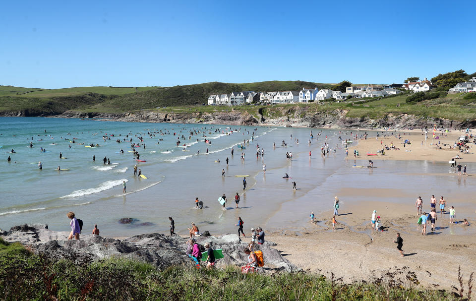 POLZEATH, ENGLAND - JULY 21: Beachgoers enjoy Polzeath beach on July 21, 2020 in Polzeath, United Kingdom. Many UK residents have decided to go on 'staycations' to Devon and Cornwall this summer during the pandemic. (Photo by Chris Jackson/Getty Images)