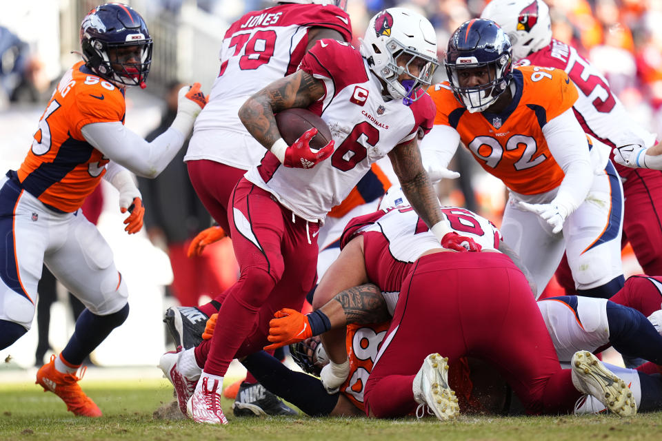 Arizona Cardinals running back James Conner (6) runs as Denver Broncos defensive tackle Jonathan Harris (92) pursues during the first half of an NFL football game, Sunday, Dec. 18, 2022, in Denver. (AP Photo/Jack Dempsey)