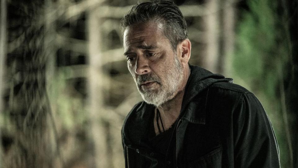 Negan looks away pensively in the walking dead finale survivor who survived