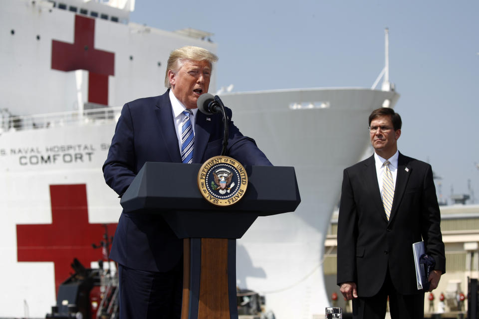 President Donald Trump speaks in front of the U.S. Navy hospital ship USNS Comfort at Naval Station Norfolk in Norfolk, Va., Saturday, March 28, 2020. The ship is departing for New York to assist hospitals responding to the coronavirus outbreak. Defense Secretary Mark Esper is at right. (AP Photo/Patrick Semansky)