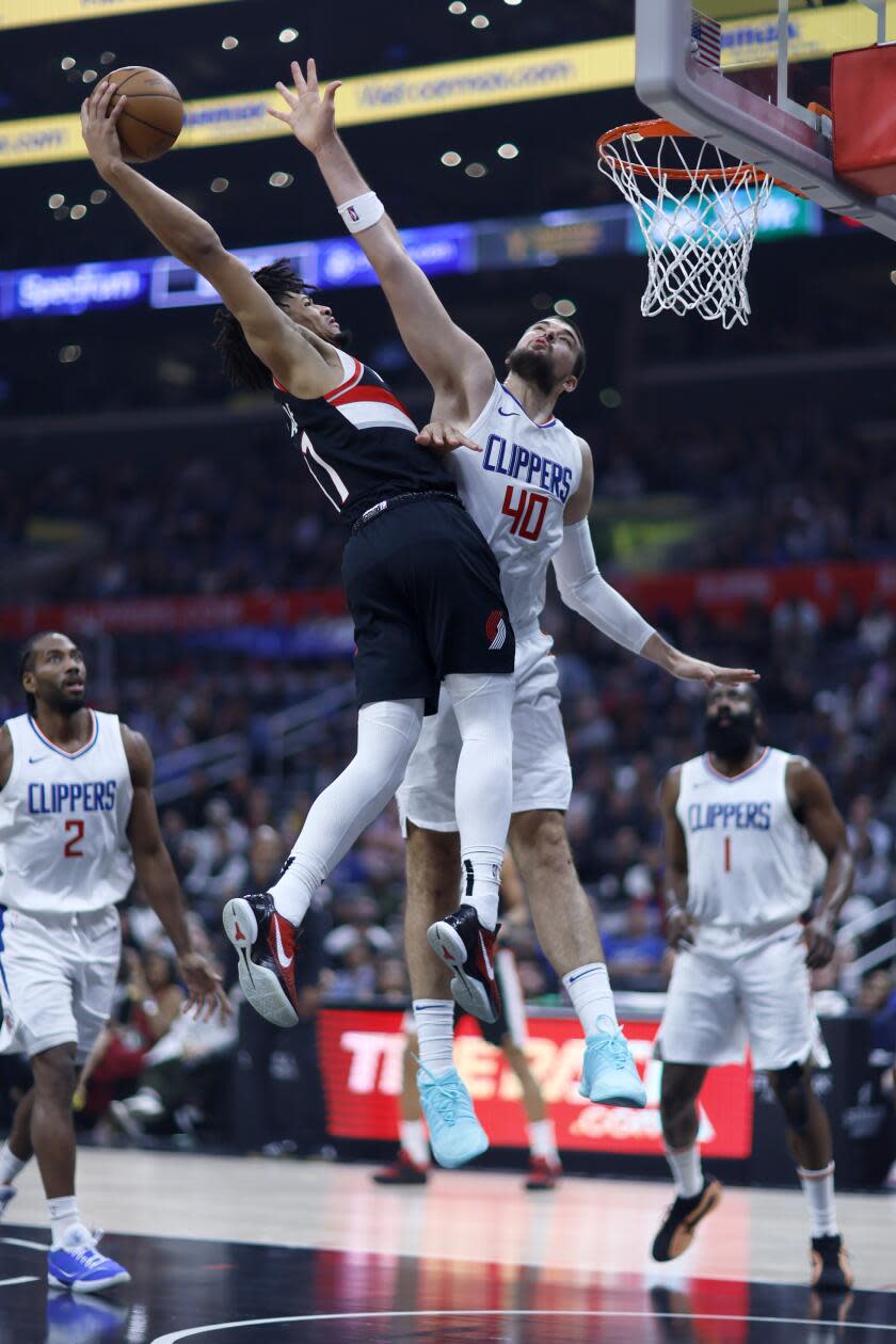 Los Angeles, CA - December 11: LA Clippers center Ivica Zubac, #40, right, fouls Portland Trail Blazers.