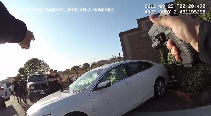 A San Mateo, California, police officer fires his gun at a car with two women - one from Delaware - who investigators said went on a 48-hour crime spree in that state.