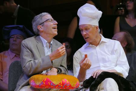 Nobel Laureates Eric Maskin (L) and Richard Roberts sample the sausage from the Ig Nobel nutrition prize study "Characterization of Lactic Acid Bacteria Isolated from Infant Faeces as Potential Probiotic Starter Cultures for Fermented Sausages" at the 24th First Annual Ig Nobel Prizes awards ceremony at Harvard University in Cambridge, Massachusetts September 18, 2014. REUTERS/Brian Snyder