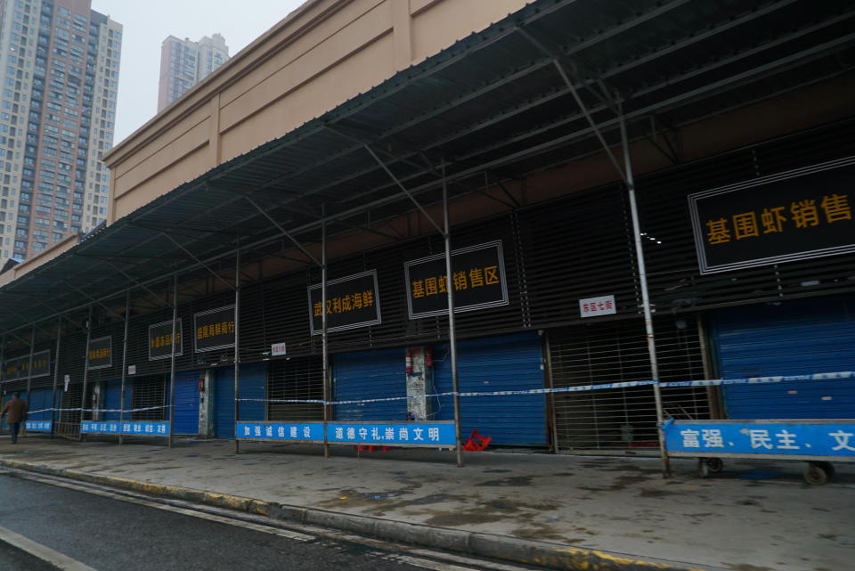 The Wuhan Huanan Wholesale Seafood Market, where a number of people related to the market fell ill with a virus, sits closed in Wuhan, China, Tuesday, Jan. 21, 2020. Heightened precautions were being taken in China and elsewhere Tuesday as governments strove to control the outbreak of the coronavirus, which threatens to grow during the Lunar New Year travel rush. (AP Photo/Dake Kang)