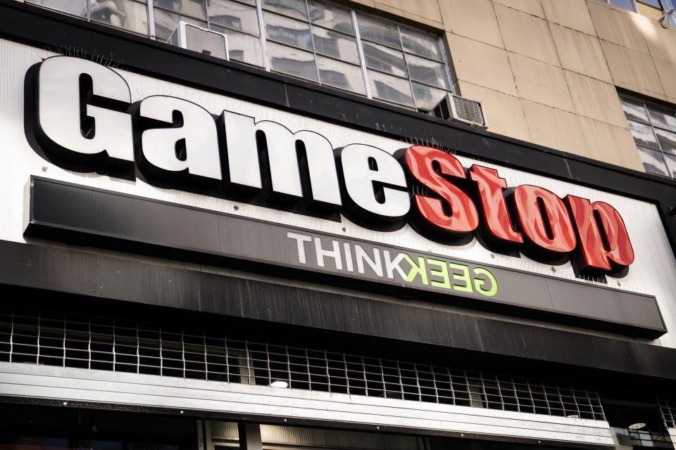 Pedestrians pass a GameStop store on 14th Street at Union Square, Thursday, Jan. 28, 2021, in the Manhattan borough of New York. Robinhood and other online trading platforms are moving to restrict trading in GameStop and other stocks that have soared recently due to rabid buying by smaller investors. GameStop stock has rocketed from below $20 to more than $400 this month as a volunteer army of investors on social media challenged big institutions who has placed market bets that the stock would fall. (AP Photo/John Minchillo)