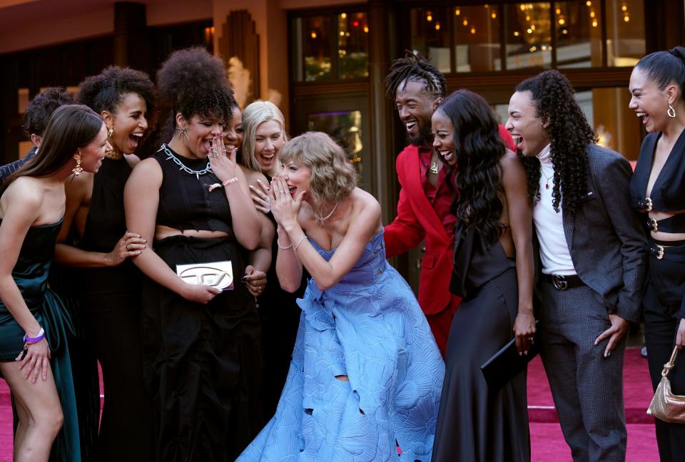 Taylor Swift, center, and tour dancers arrive at the world premiere of the concert film "Taylor Swift: The Eras Tour" on Wednesday at AMC The Grove 14 in Los Angeles.