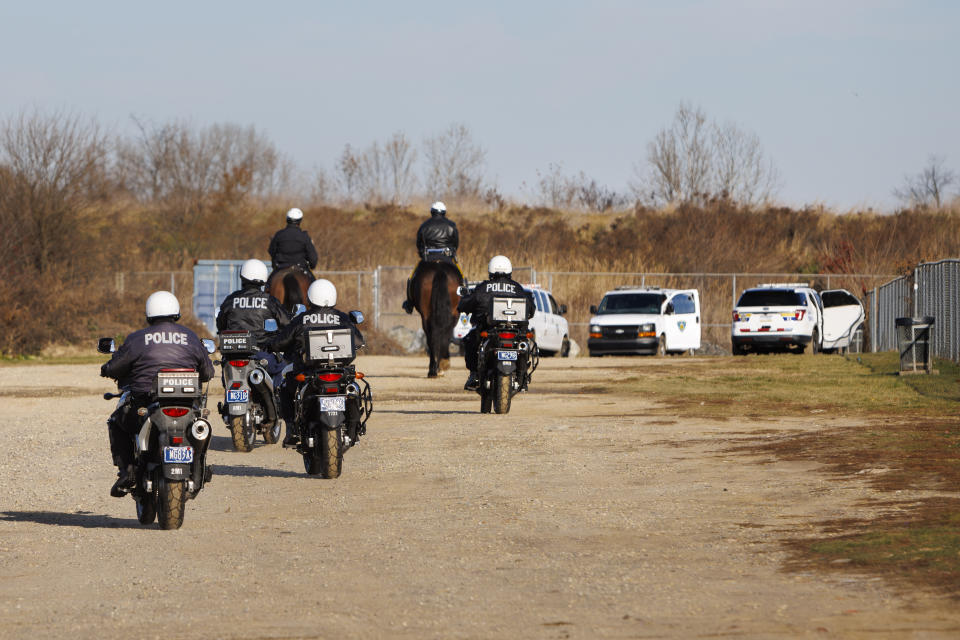 Philadelphia police mounted police and Prison guards in park behind prison complex in search for an escaped prisoner from prison complex on Thursday, Nov. 30, 2023. Police were searching on Friday, Dec. 1, 2023, for Gino Hagenkotter, an inmate who escaped from a Philadelphia jail by walking away from a work detail, the fourth breakout from a city lockup this year. (Alejandro A. Alvarez/The Philadelphia Inquirer via AP)