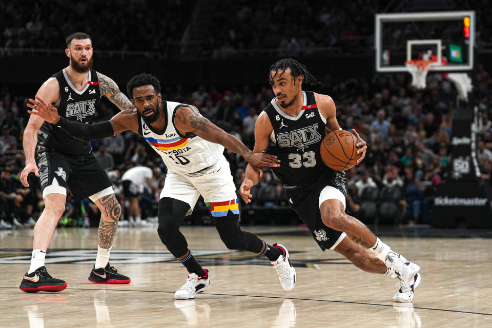 San Antonio Spurs guard Tre Jones (33) pushes past Minnesota Timberwolves guard Mike Conley (10) during the game at the Moody Center on Saturday, April 8, 2023 in Austin.